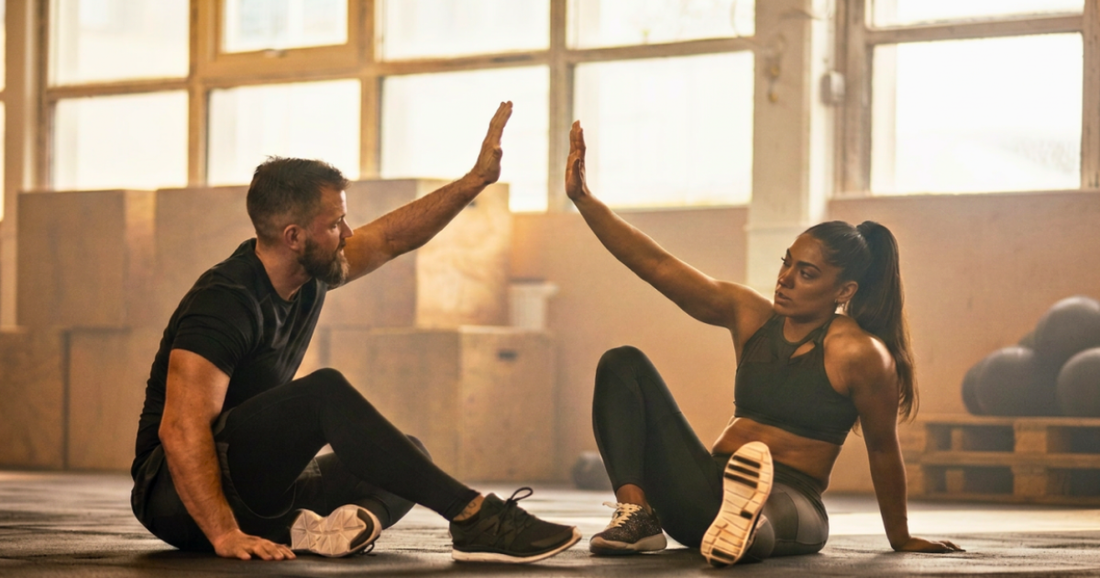 Gym buddies giving a high-five