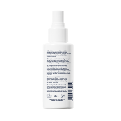 A white plastic Renew Toner facial mist bottle with a translucent cap and a multilingual label on the back. Designed to calm redness and reduce blemishes, it includes recycling symbols and a barcode near the bottom.