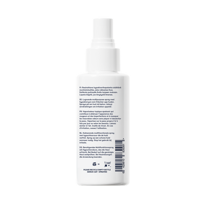 A white spray bottle with a pump top, shown from the back, features text instructions and product details in multiple languages. The Topical Skin Spray is perfect for soothing skin—helping to calm irritation and reduce blemishes for a clearer, healthier-looking complexion.